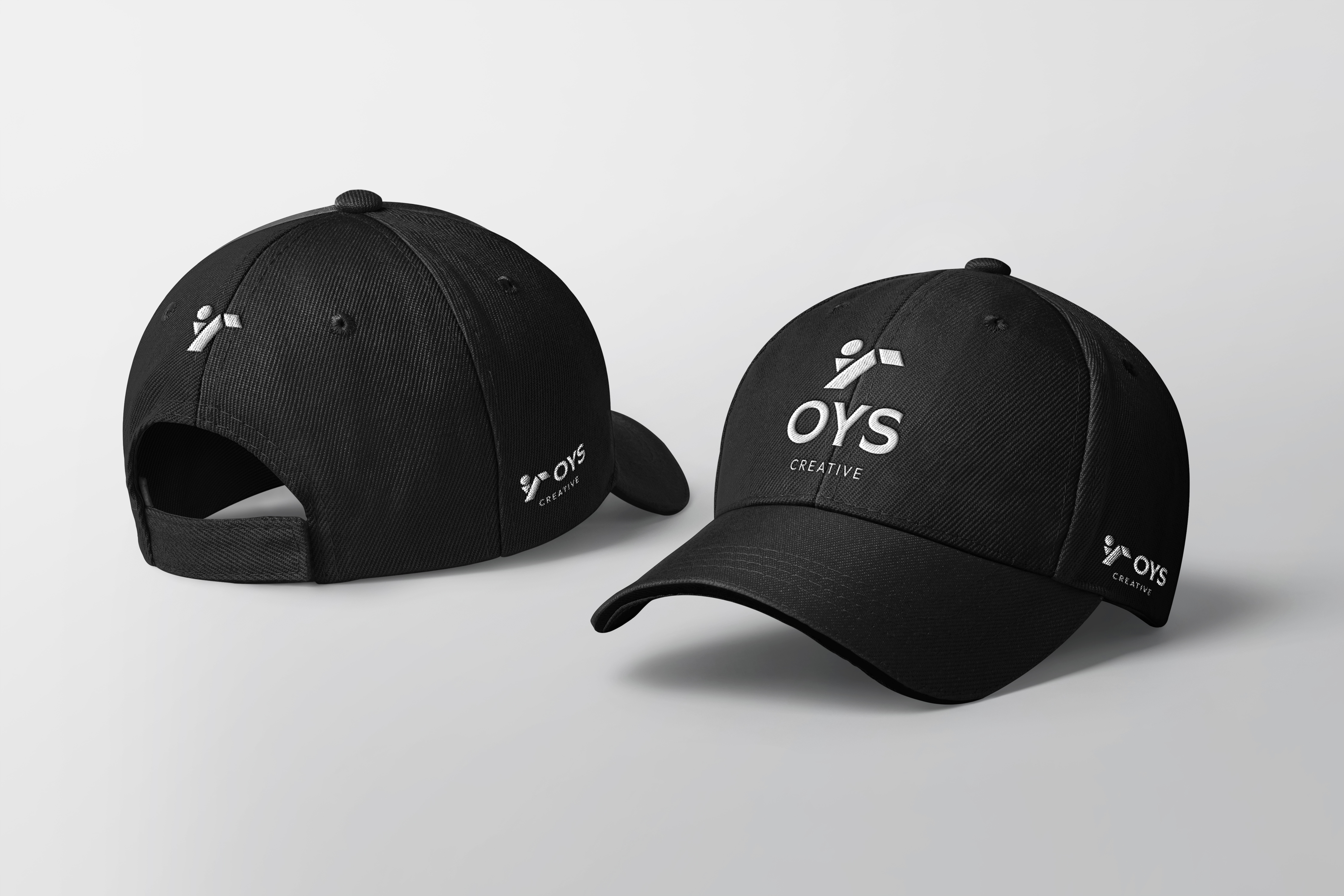 OYS Creative premium embroidered black twill caps showing front combination lockup and side monogram details